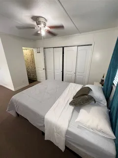 a bedroom with a bed and a large mirror