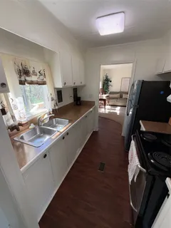 a living room with furniture and a air conditioner vent