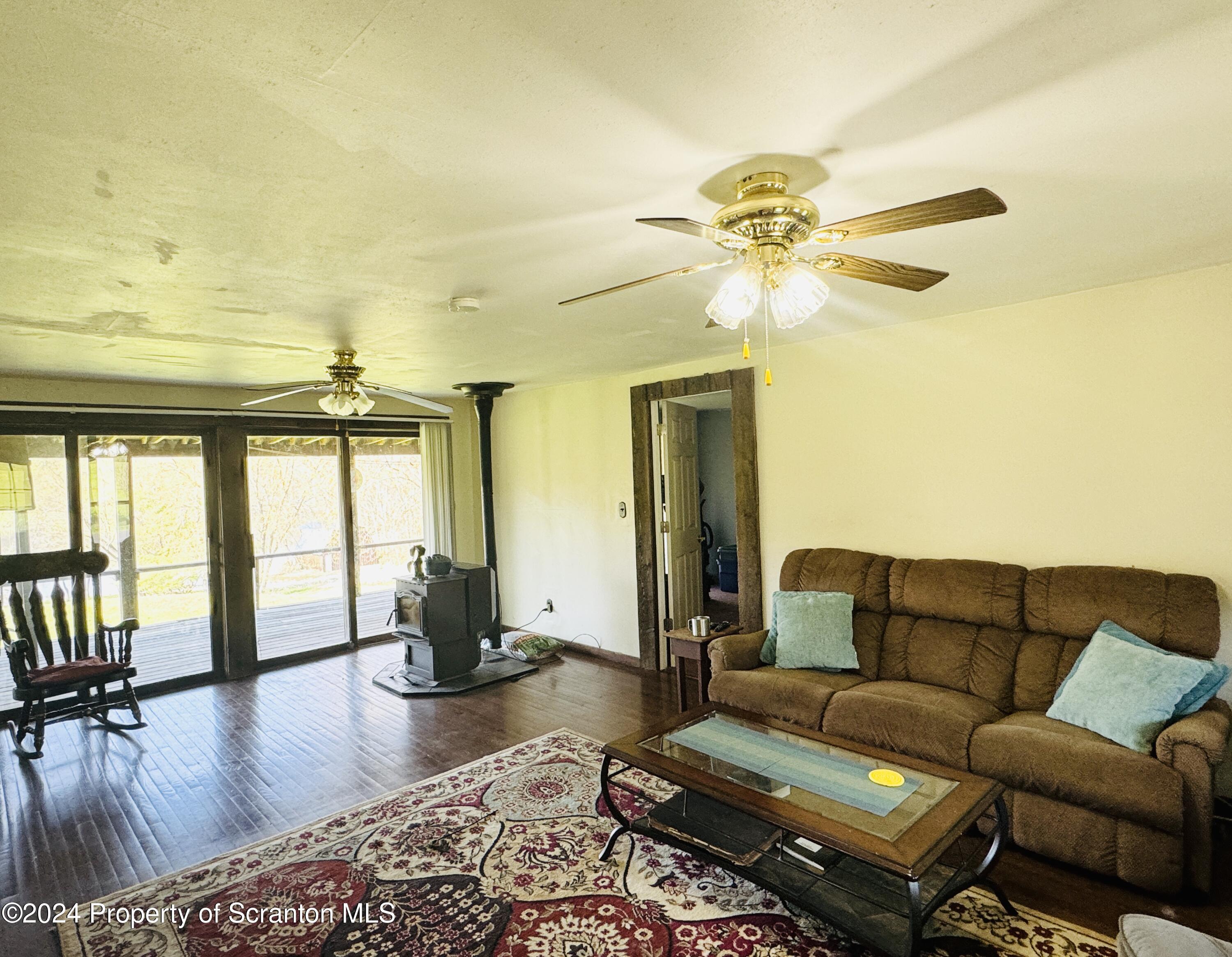 1590 State Rte 4002 Mehoopany, PA 18629 - Photo 11 of 38 a living room with furniture and a large window