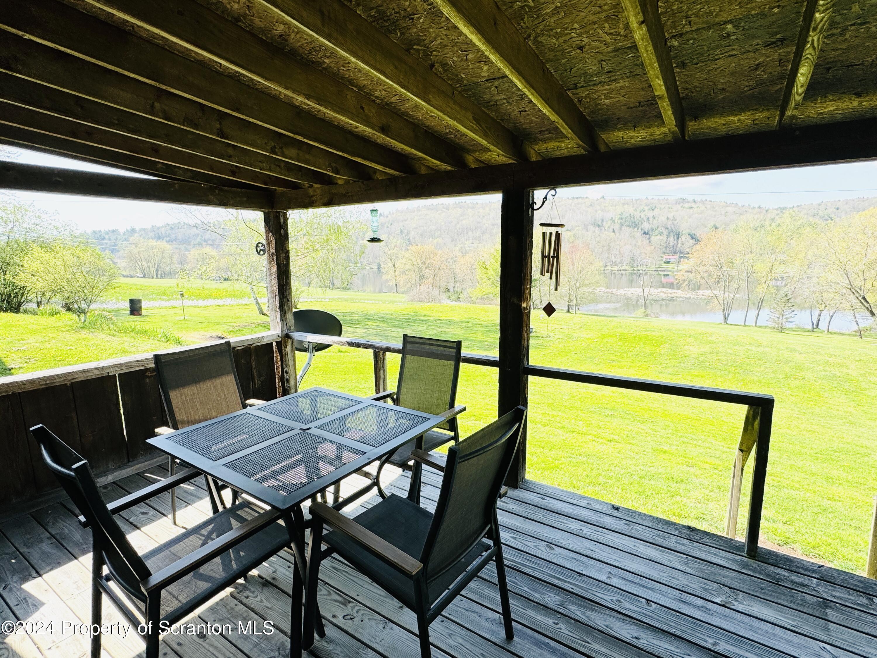 1590 State Rte 4002 Mehoopany, PA 18629 - Photo 24 of 38 a view of a swimming pool with a table and chairs