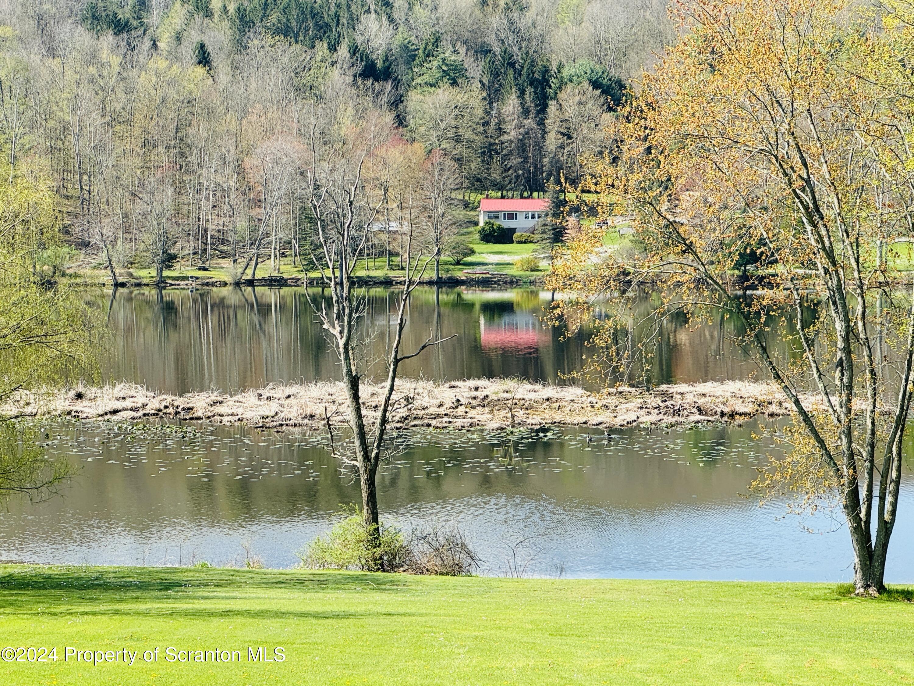 1590 State Rte 4002 Mehoopany, PA 18629 - Photo 28 of 38 a view of a lake with a yard and trees