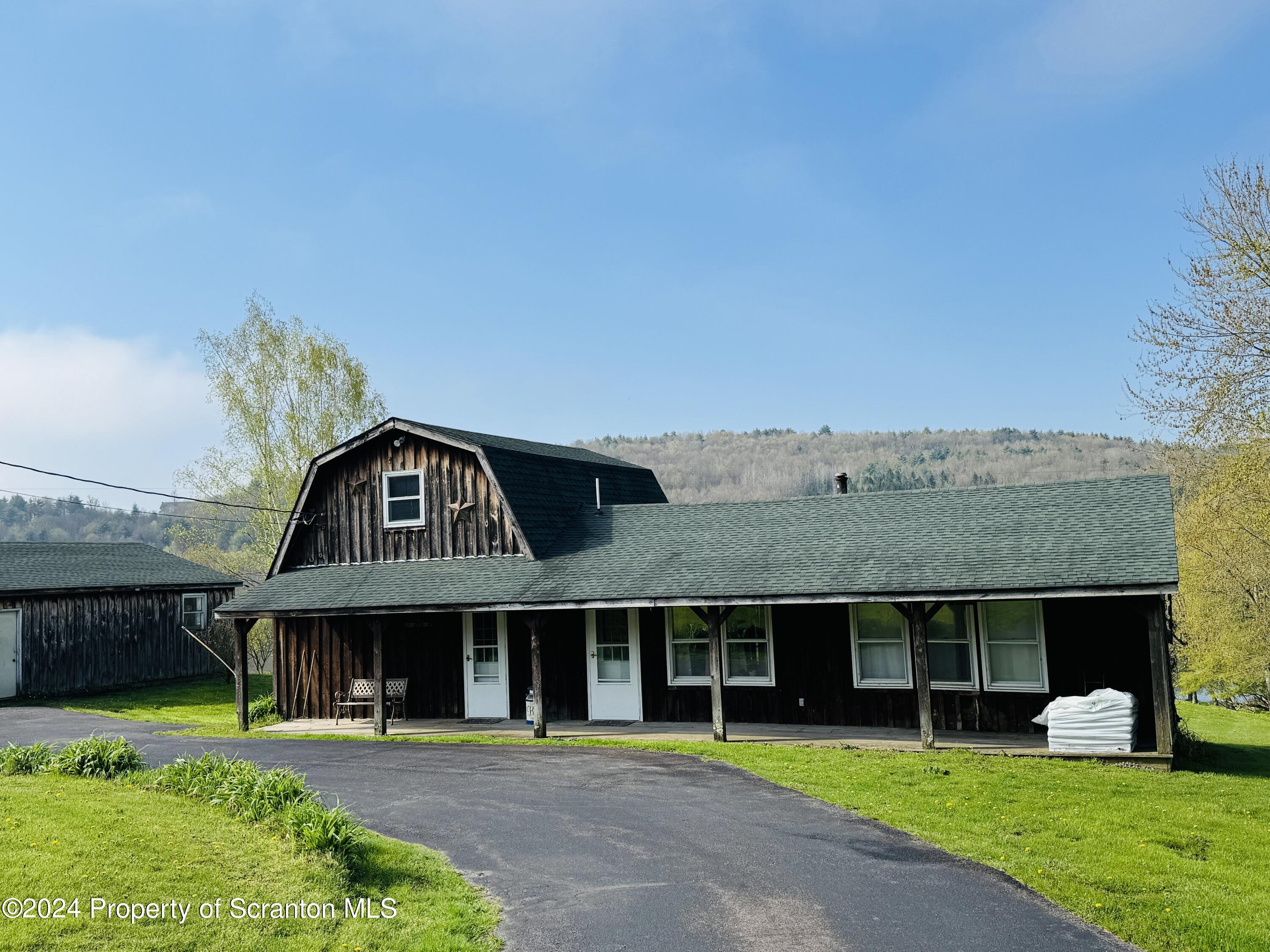 1590 State Rte 4002 Mehoopany, PA 18629 - Photo 36 of 38 a front view of a house with garden