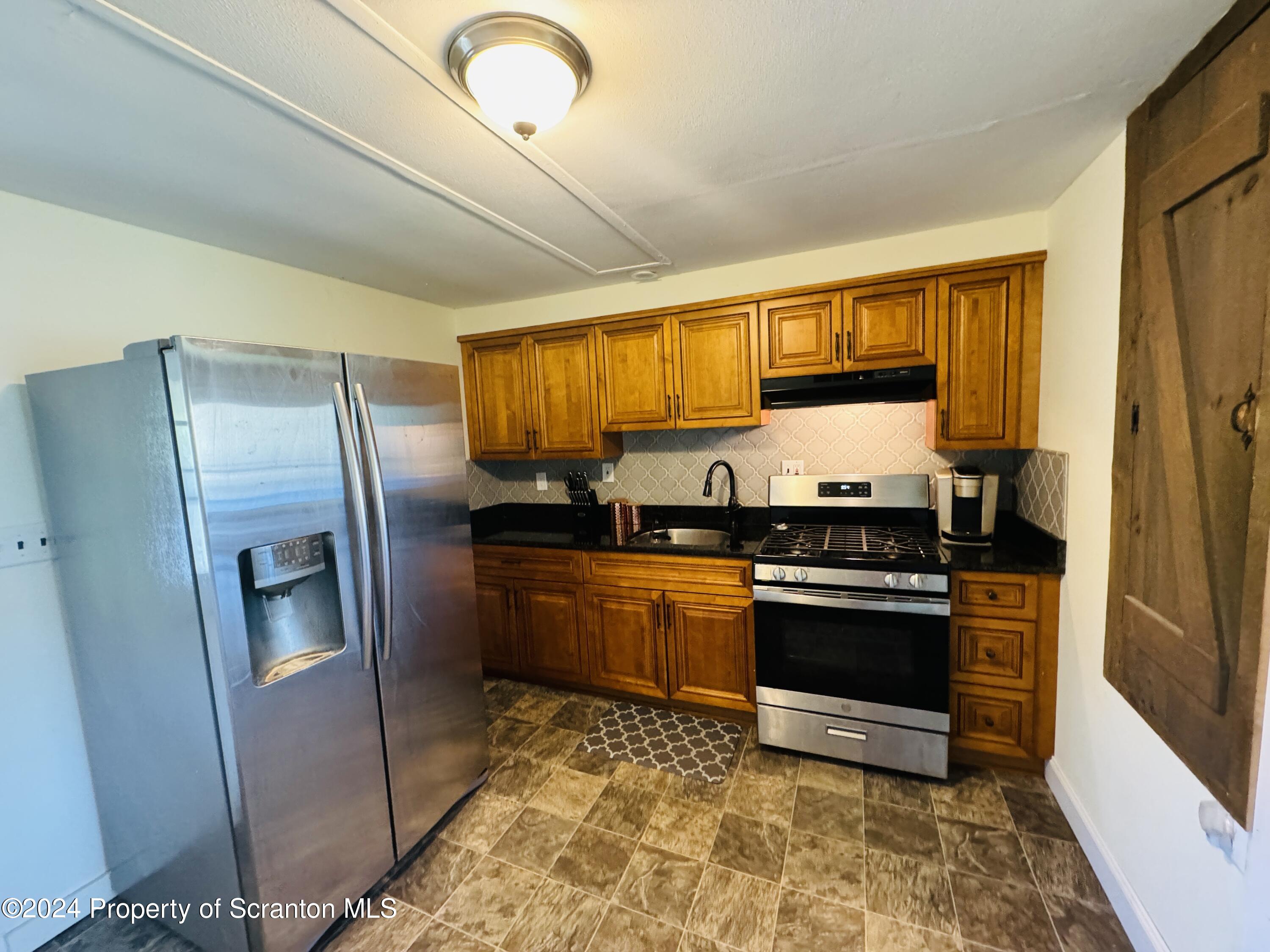 1590 State Rte 4002 Mehoopany, PA 18629 - Photo 5 of 38 a kitchen with stainless steel appliances granite countertop a refrigerator stove and sink