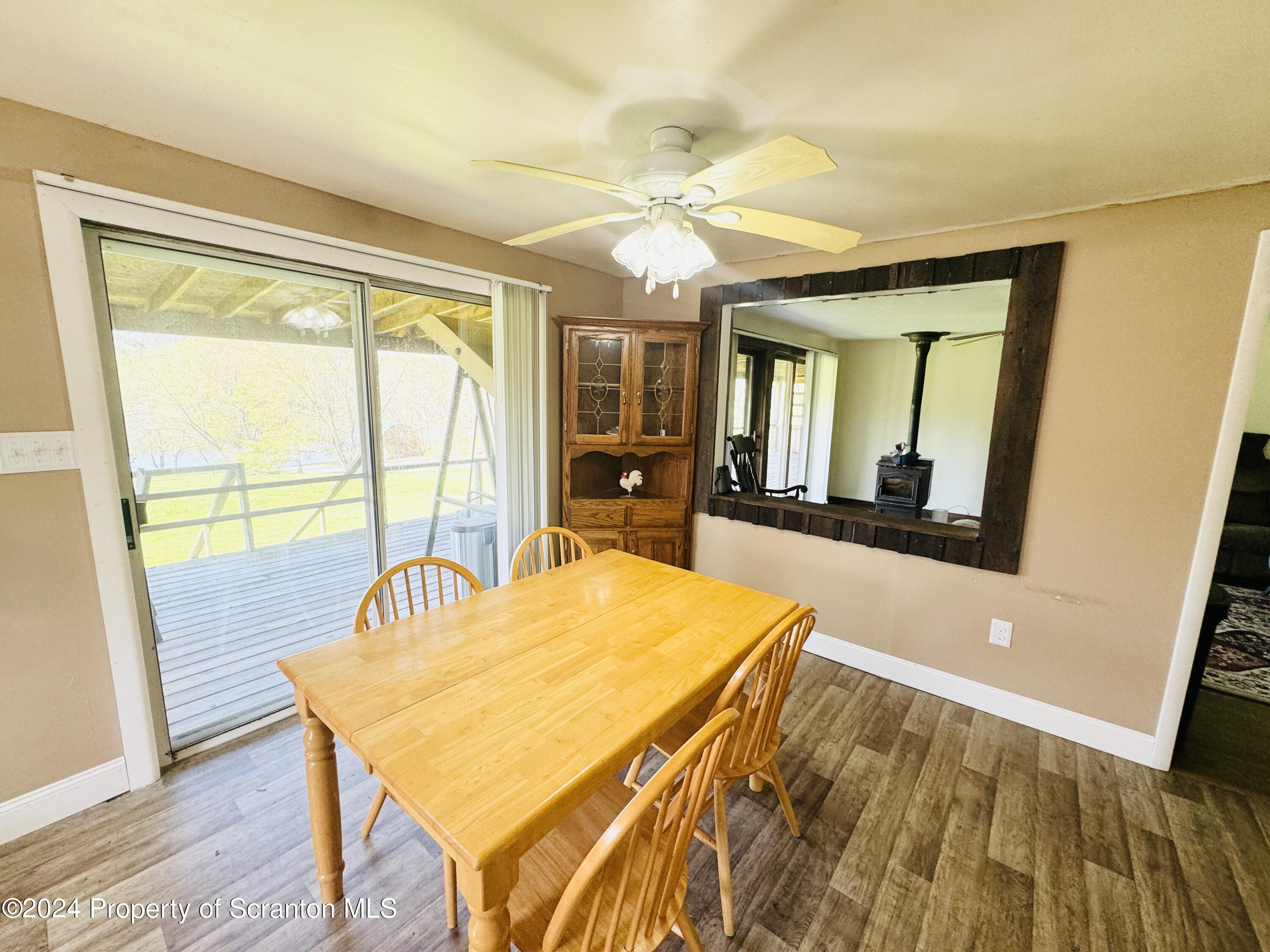 1590 State Rte 4002 Mehoopany, PA 18629 - Photo 8 of 38 a view of a dining room with furniture a chandelier and wooden floor