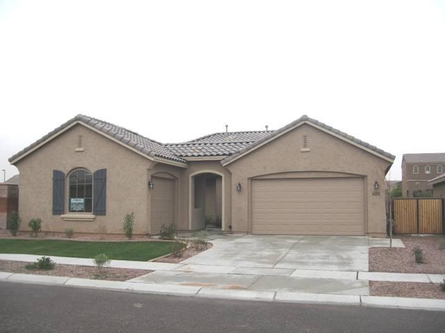 2851 East Blue Sage Road Gilbert, AZ 85297 - Photo 1 of 14 a front view of a house with a yard and garage