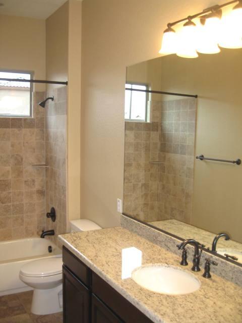 2851 East Blue Sage Road Gilbert, AZ 85297 - Photo 12 of 14 a bathroom with a granite countertop sink a toilet and shower