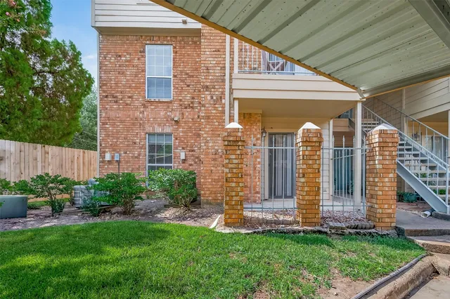 a view of front door of house with a yard