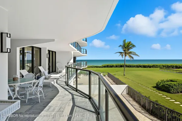 a view of a balcony with swimming pool and furniture