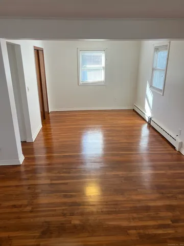 a view of room with window and wooden floor