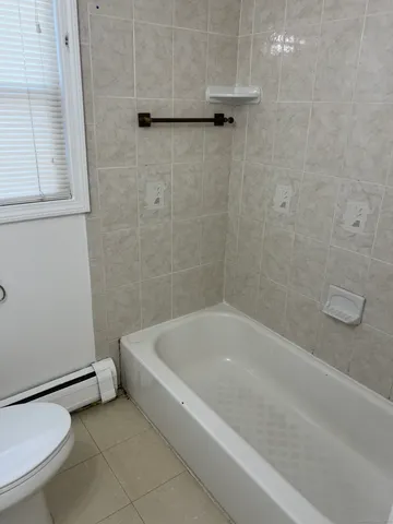 a bath tub sitting next to a white toilet