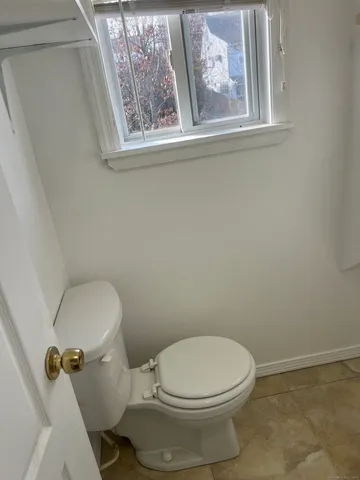 a white toilet sitting next to a bathroom sink