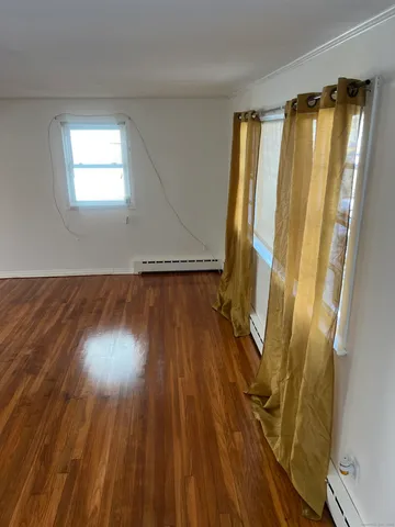 a view of front door with wooden floor and a window