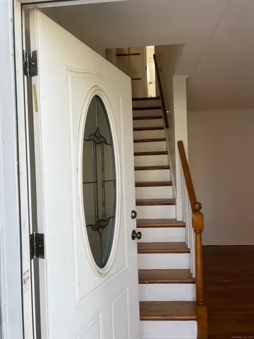 a view of a livingroom with wooden floor and white walls