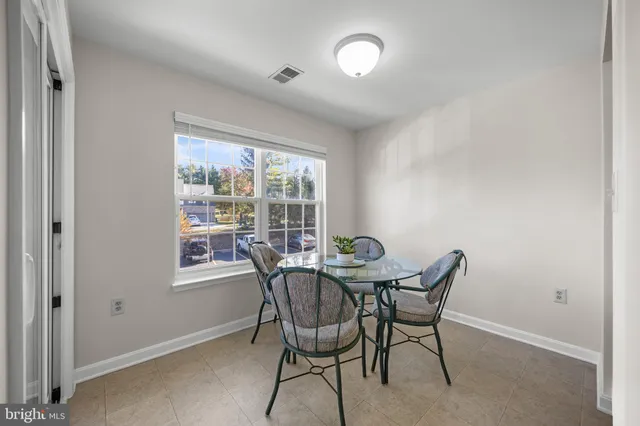 a view of a dining room with furniture and a window