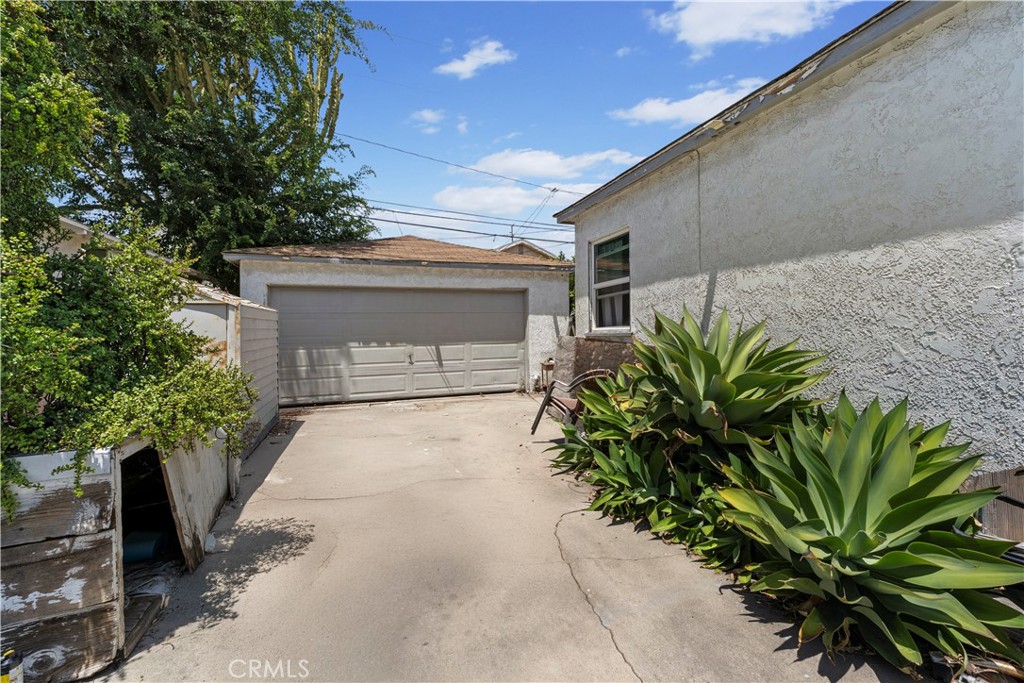 2725 East Tyler Street Carson, CA 90810 - Photo 21 of 30 a front view of a house with a yard and garage