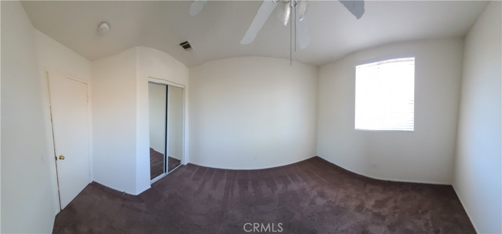31975 Corte Algete Temecula, CA 92592 - Photo 12 of 15 an empty room with wooden floor and windows