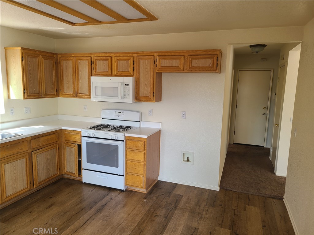 31975 Corte Algete Temecula, CA 92592 - Photo 2 of 15 a kitchen with granite countertop a stove a sink and a refrigerator