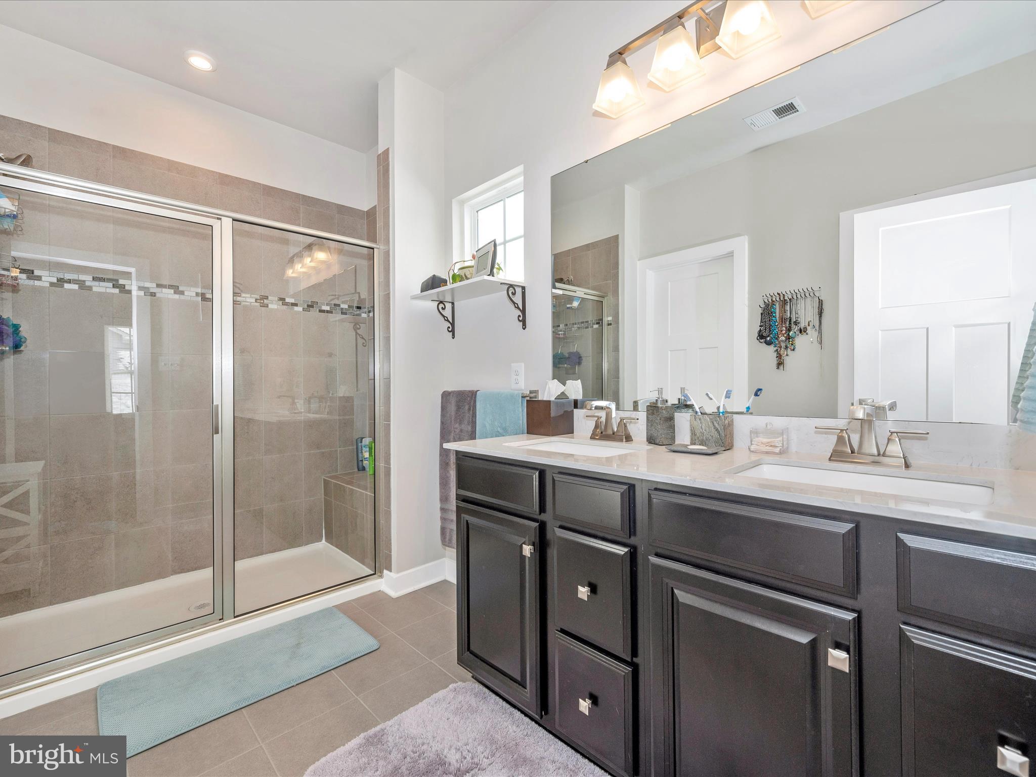 6649 Ballenger Run Boulevard Frederick, MD 21703 - Photo 21 of 42 a bathroom with a shower sink and mirror