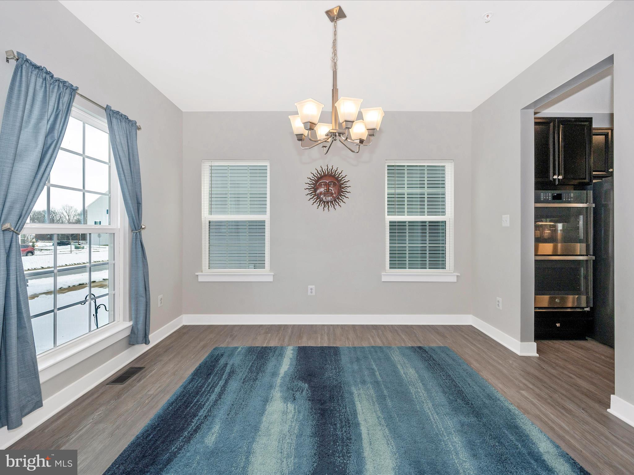 6649 Ballenger Run Boulevard Frederick, MD 21703 - Photo 6 of 42 a view of an empty room with wooden floor and a window