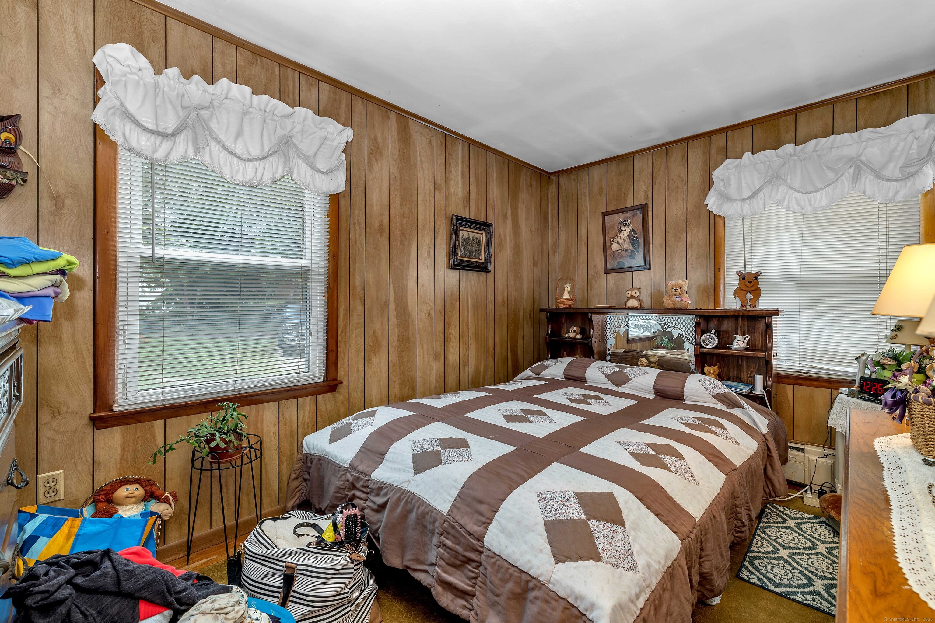398 Boston Post Road Waterford, CT 06385 - Photo 14 of 40 a bedroom with a bed and wooden floor