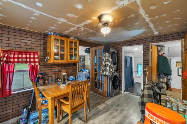 a kitchen filled with stainless steel appliances kitchen island granite countertop a table and chairs in it