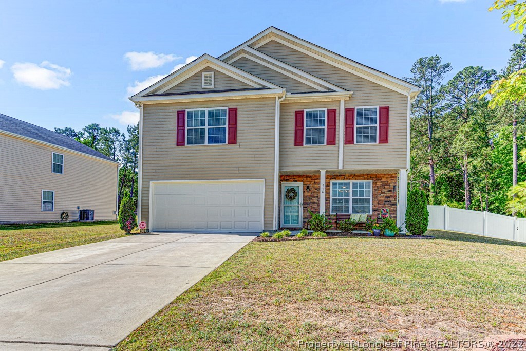 448 Botanical Court Bunnlevel, NC 28323 - Photo 1 of 37 a front view of a house with a yard and garage