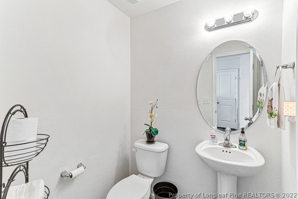 448 Botanical Court Bunnlevel, NC 28323 - Photo 16 of 37 a bathroom with a toilet a sink and a mirror