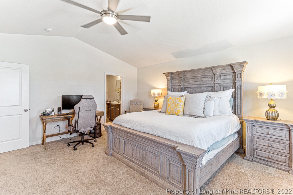 448 Botanical Court Bunnlevel, NC 28323 - Photo 20 of 37 a bedroom with a bed a desk and chair
