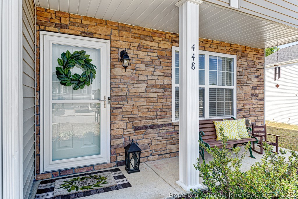 448 Botanical Court Bunnlevel, NC 28323 - Photo 2 of 37 a view of a door with a chairs and table in a patio