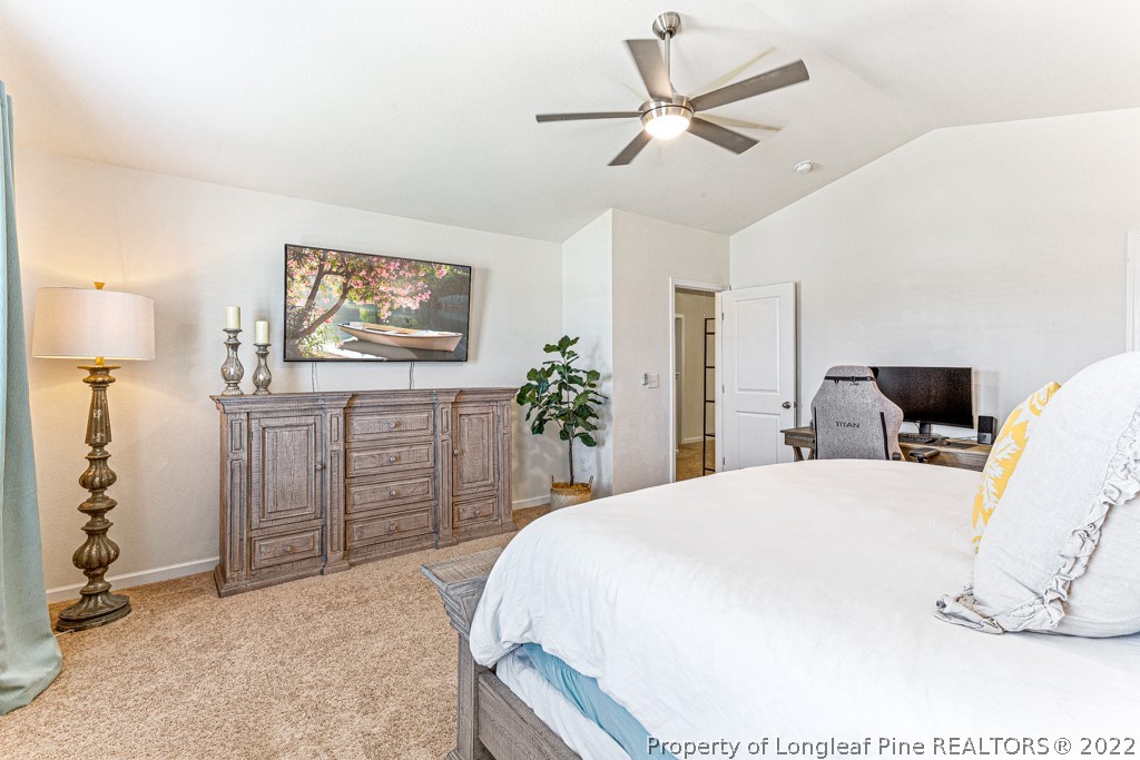 448 Botanical Court Bunnlevel, NC 28323 - Photo 21 of 37 a bedroom with a bed and a chandelier