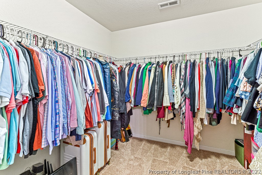 448 Botanical Court Bunnlevel, NC 28323 - Photo 24 of 37 a view of walk in closet with clothes