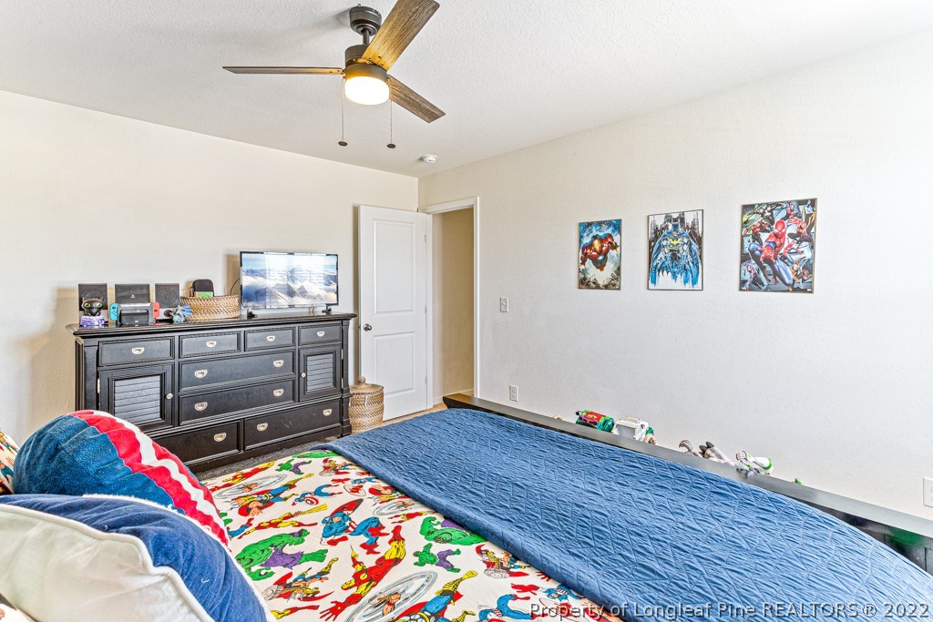 448 Botanical Court Bunnlevel, NC 28323 - Photo 27 of 37 a living room with baby bed and dresser