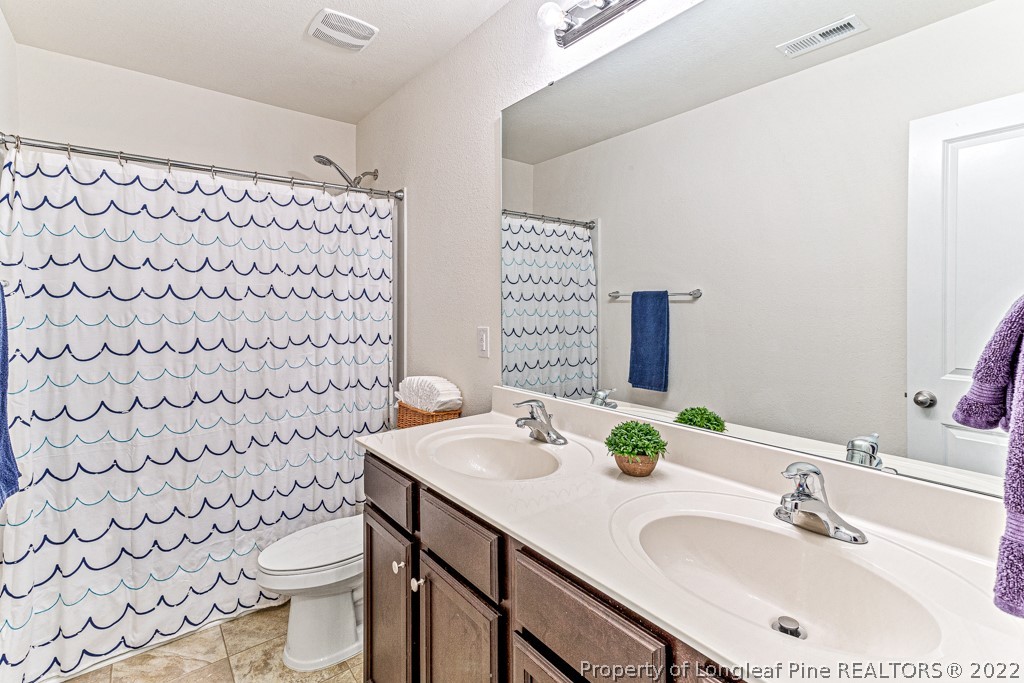 448 Botanical Court Bunnlevel, NC 28323 - Photo 28 of 37 a bathroom with a sink toilet and shower
