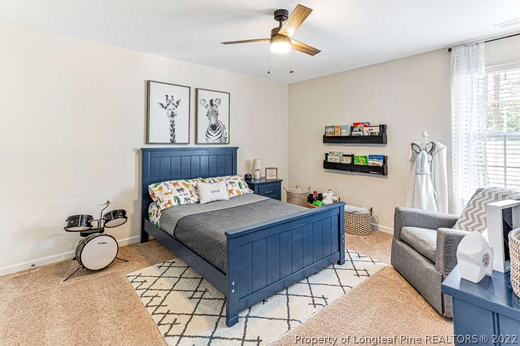 448 Botanical Court Bunnlevel, NC 28323 - Photo 29 of 37 a bedroom with a bed and ceiling fan