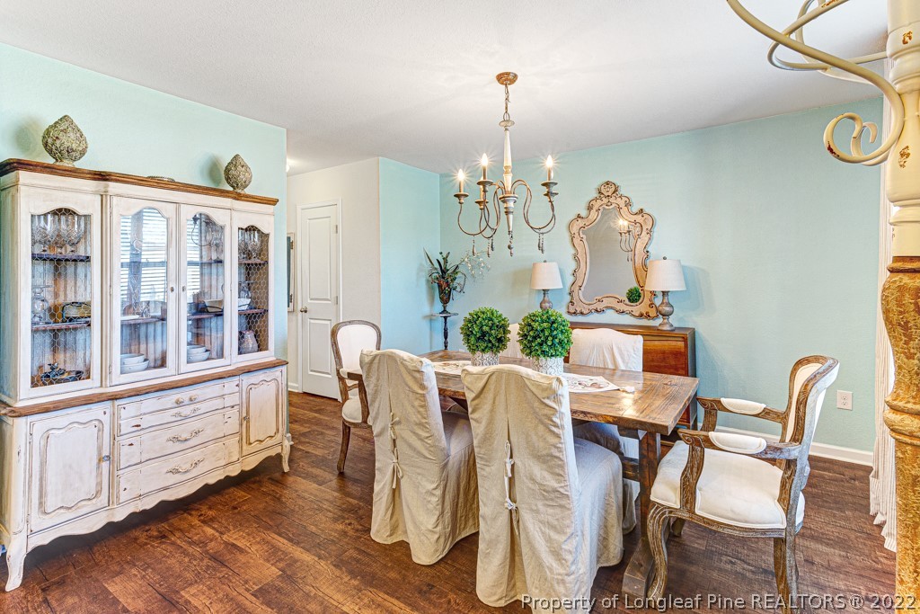 448 Botanical Court Bunnlevel, NC 28323 - Photo 4 of 37 a view of a dining room with furniture a chandelier and wooden floor