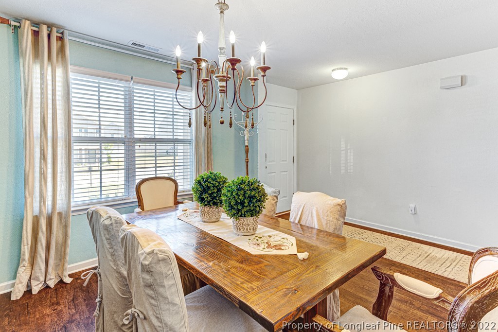 448 Botanical Court Bunnlevel, NC 28323 - Photo 5 of 37 a view of a dining room with furniture and wooden floor