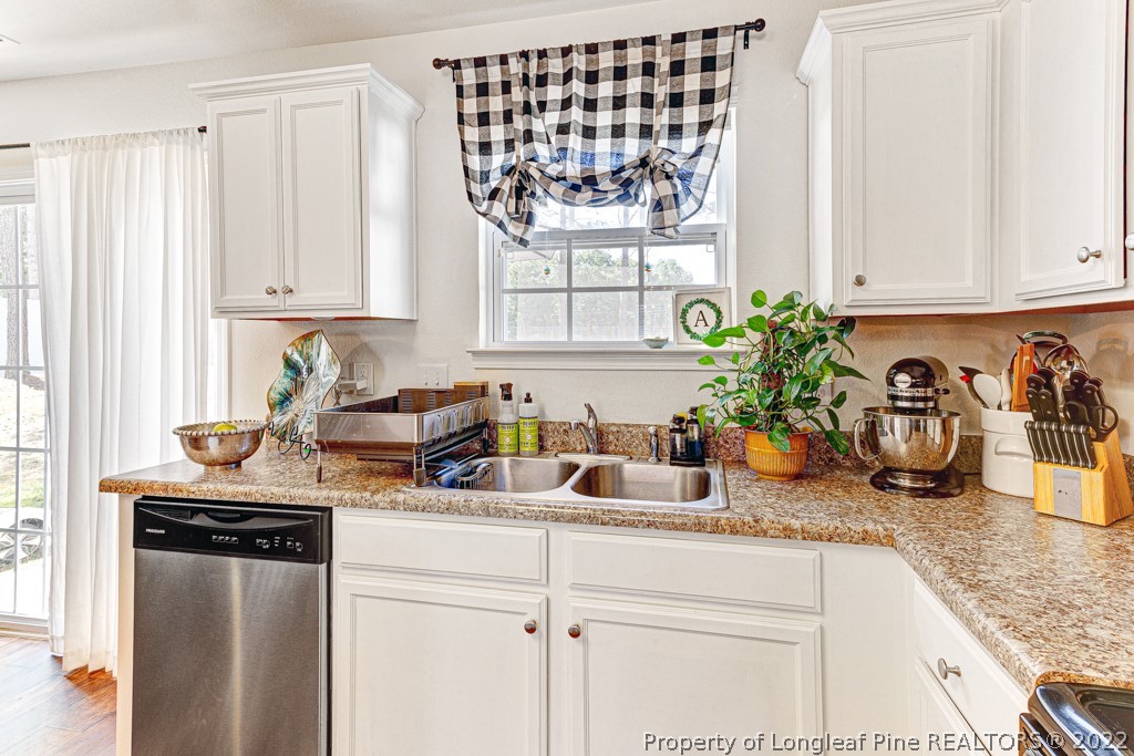 448 Botanical Court Bunnlevel, NC 28323 - Photo 8 of 37 a kitchen with sink cabinets and window