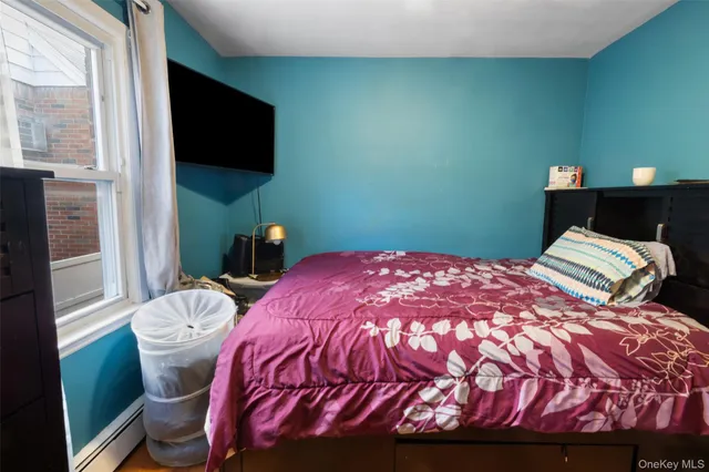 a bedroom with a bed and flat screen tv