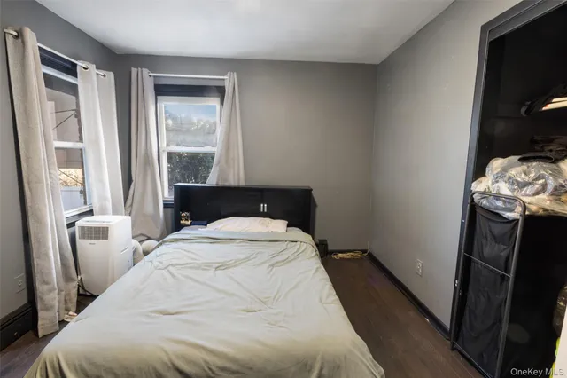 a bed sitting in a bedroom next to a window