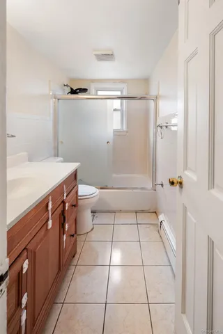a bathroom with a sink a toilet and a shower