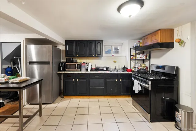 a kitchen with a stove a refrigerator and cabinets