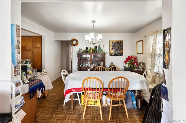 a view of a dining room with furniture and chandelier