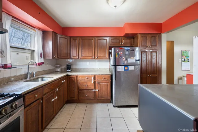 a kitchen with stainless steel appliances granite countertop a refrigerator and a sink