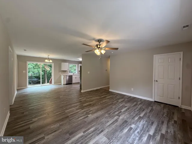 a view of a room with wooden floor gym equipment and windows