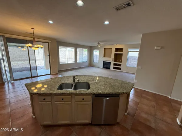 a kitchen with sink refrigerator and window