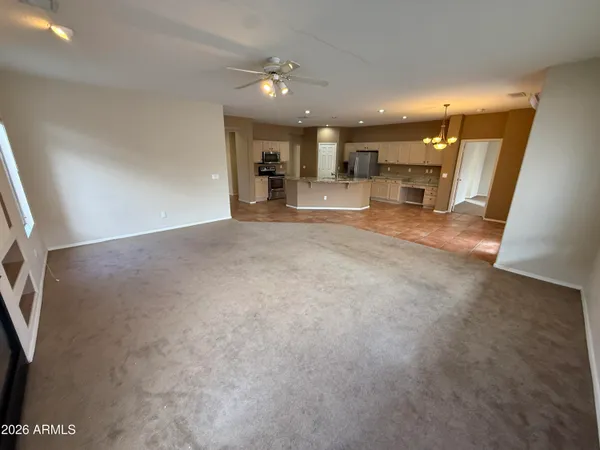a view of a livingroom with furniture and a kitchen