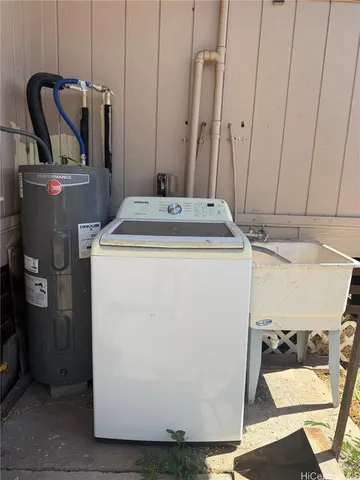 a view of a storage and utility room with washer and dryer