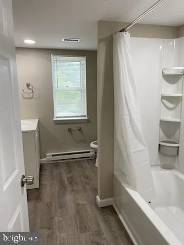 a bathroom with a bathtub and a shower