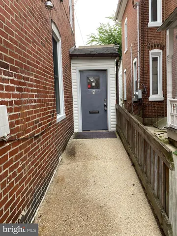 a view of a brick house with wooden stairs