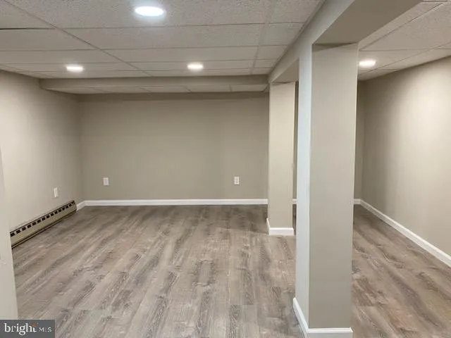 a view of a room with wooden floor
